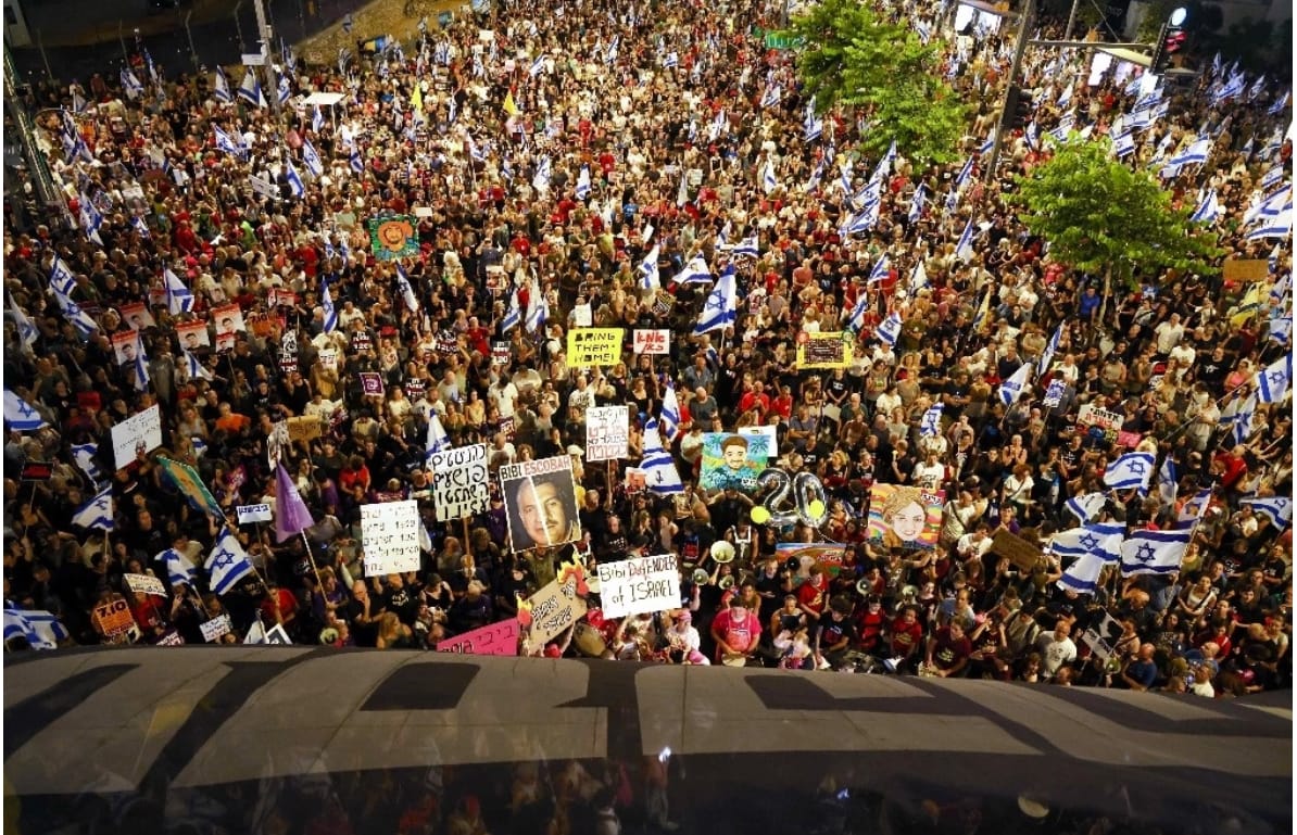 A large crowd of people protesting

Description automatically generated